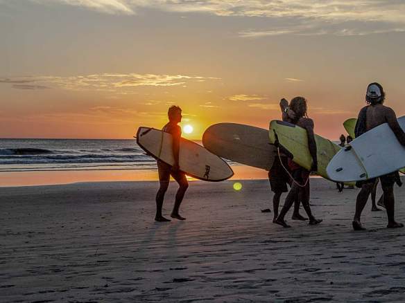 teenagers surfing in Tamarindo