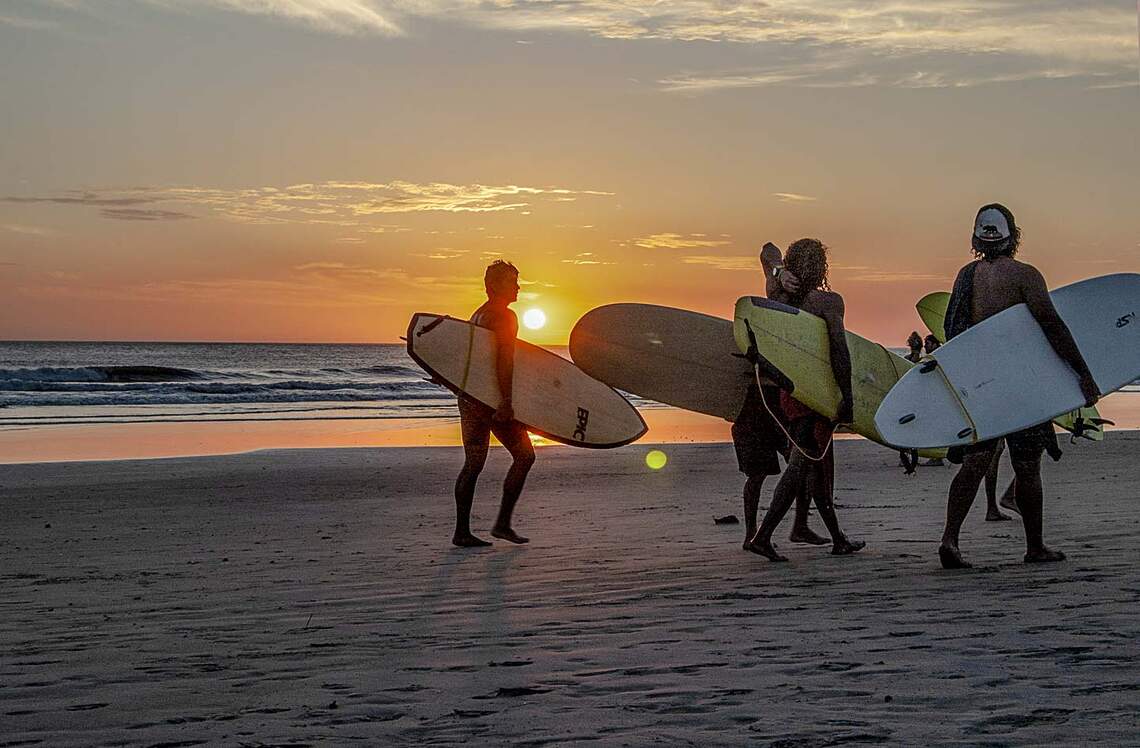 teenagers surfing in Tamarindo